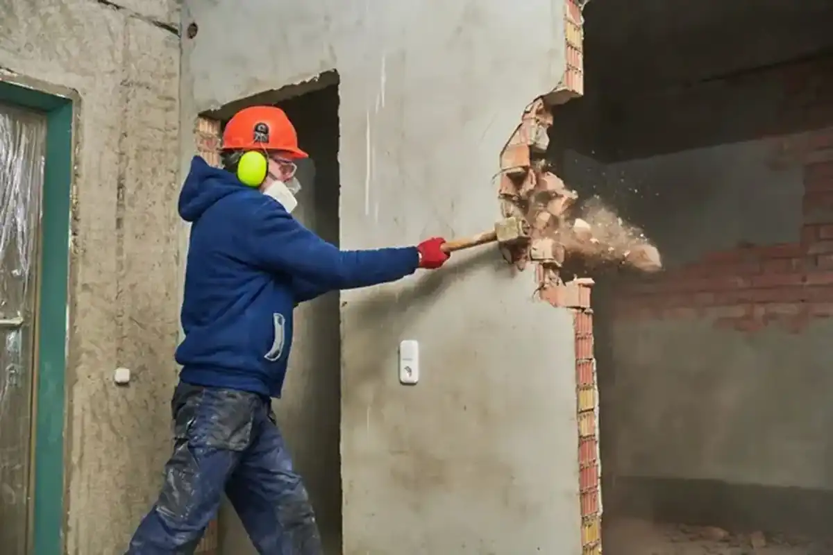 Balyozla tuğla duvar kıran işçi